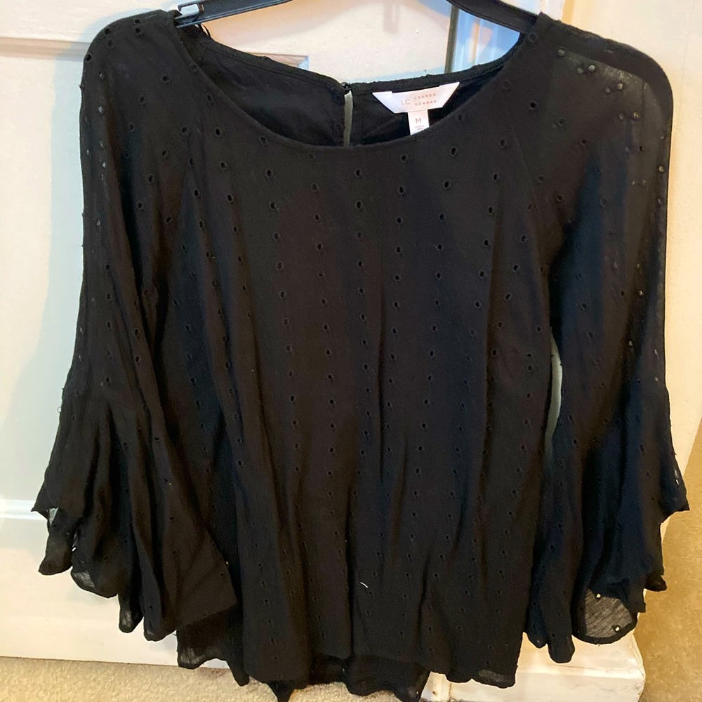 Black eyelet blouse with lower back slit and ball sleeves